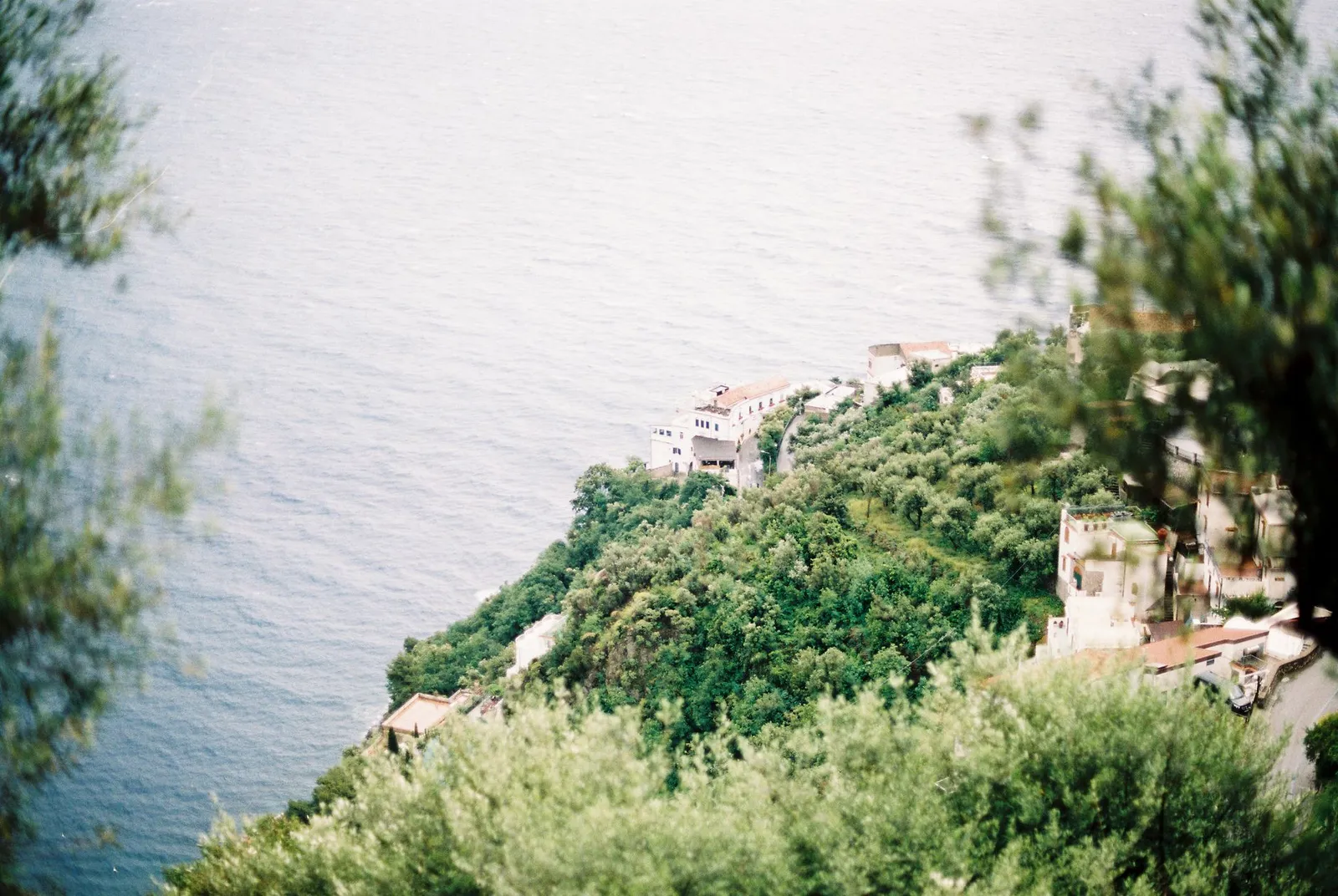 Amalfi Coast: Lush green hills meeting the vast blue Tyrrhenian Sea on the Amalfi Coast, Italy.