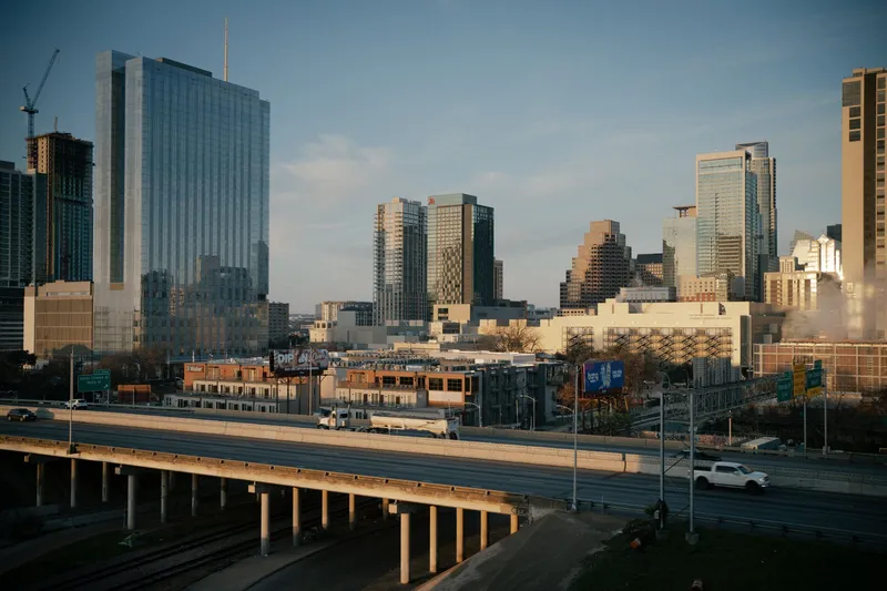 Aerial view of downtown Austin, Texas showcasing modern skyscrapers and urban infrastructure at dusk.