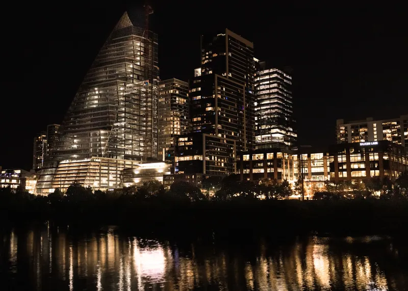 Austin: Illuminated skyscrapers reflecting in the river at night in downtown Austin, Texas.