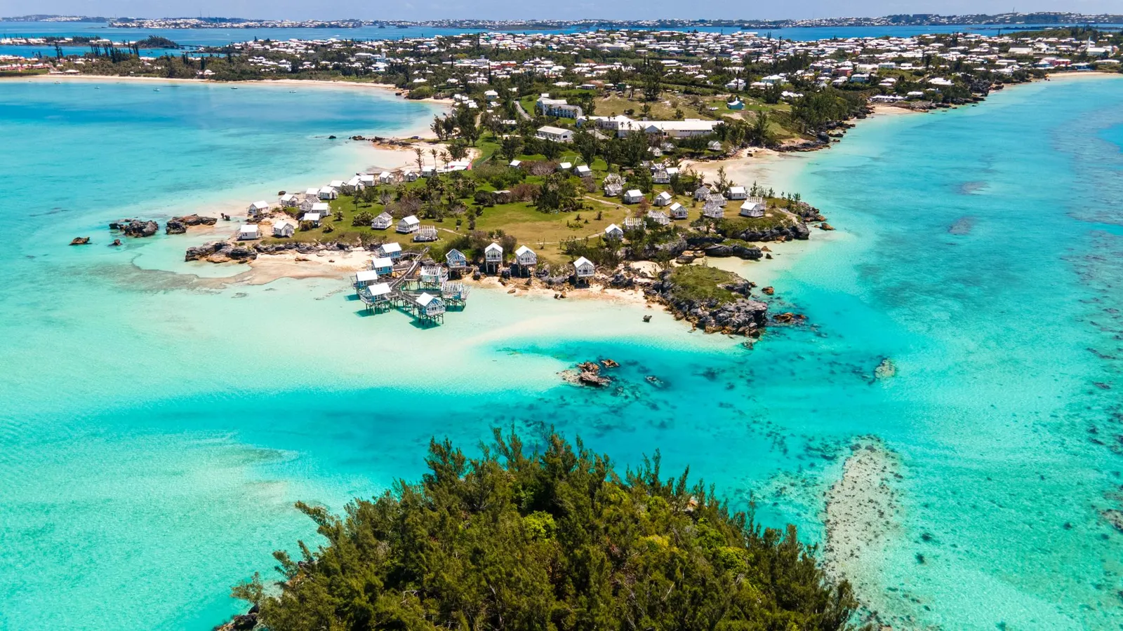 Bermuda: A stunning aerial shot capturing Bermuda's coastline with vibrant turquoise waters and charming houses.