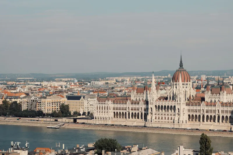 Budapest: Scenic view of the iconic Hungarian Parliament Building along the Danube River in Budapest.