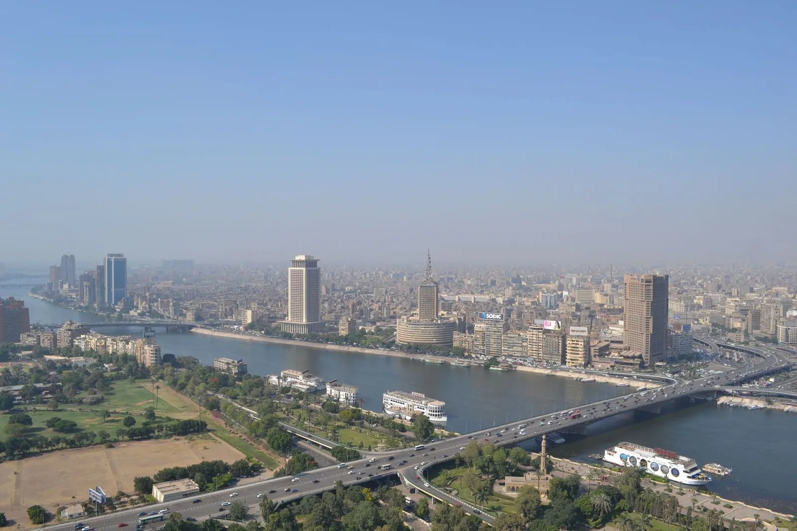 Cairo & the Nile: Aerial view of downtown Cairo with Nile River and urban skyline showcasing landmarks and busy traffic.