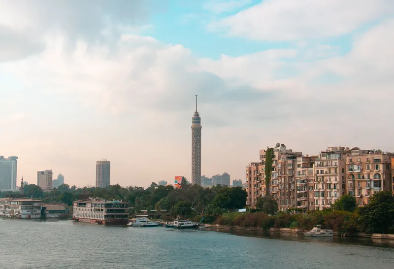 Cairo & the Nile: Beautiful view of Cairo skyline featuring the iconic Cairo Tower and downtown architecture along the Nile River.