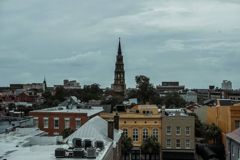 Charleston: A picturesque view of Charleston, SC, featuring a historic church tower amidst vibrant buildings.