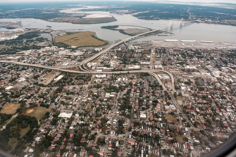 Charleston: A stunning aerial photograph of Charleston, South Carolina, showcasing the city's layout and the iconic Arthur Ravenel Jr. Bridge.