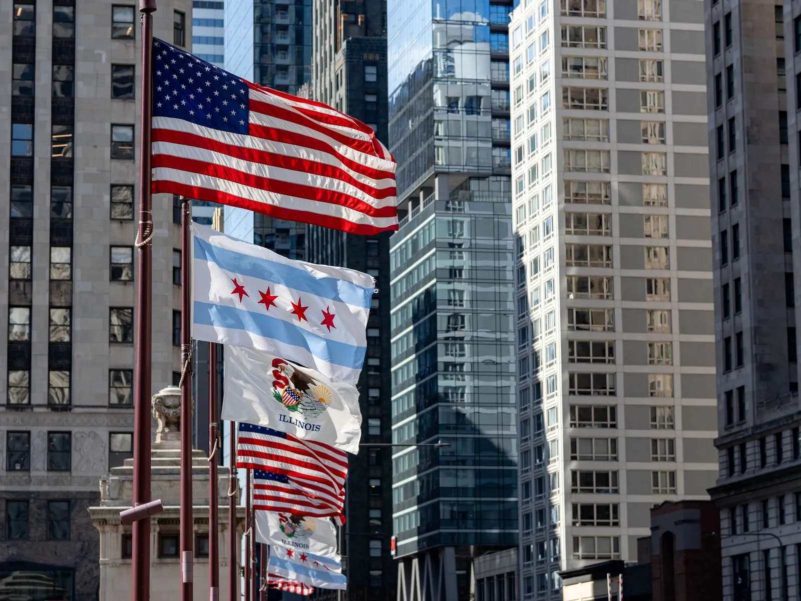 Chicago: Flags of the United States and Chicago against a backdrop of downtown skyscrapers.