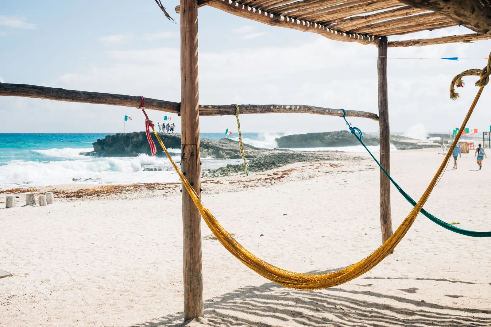 Relaxing hammock scene on a sandy beach in Cozumel, Mexico with a stunning coastal view.