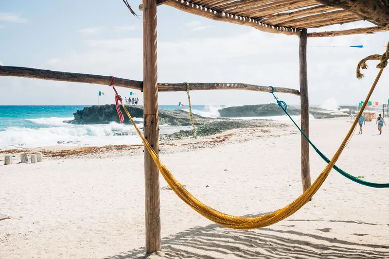 Cozumel: Relaxing hammock scene on a sandy beach in Cozumel, Mexico with a stunning coastal view.