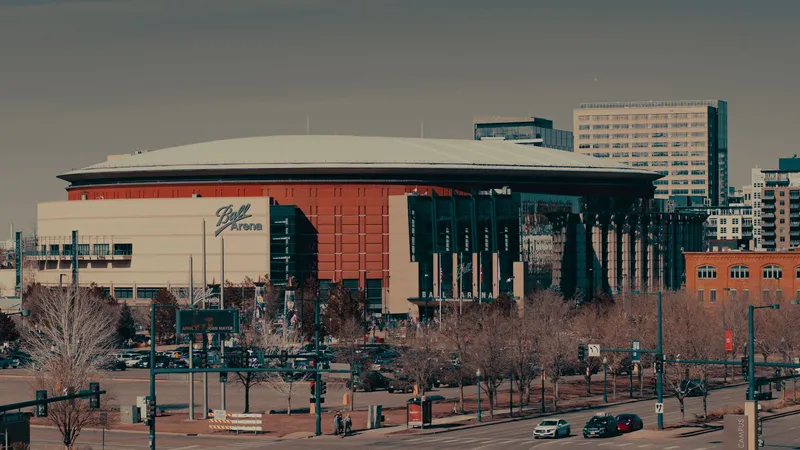 Denver: A daylight view of Ball Arena amidst Denver's urban landscape, highlighting its architectural design.