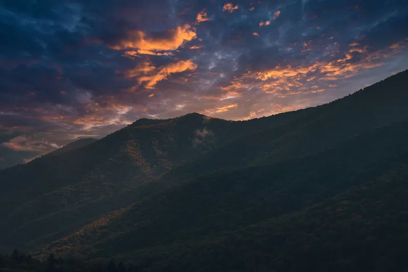Great Smoky Mountains: Breathtaking sunset over the Smoky Mountains with vivid skies and silhouetted peaks.