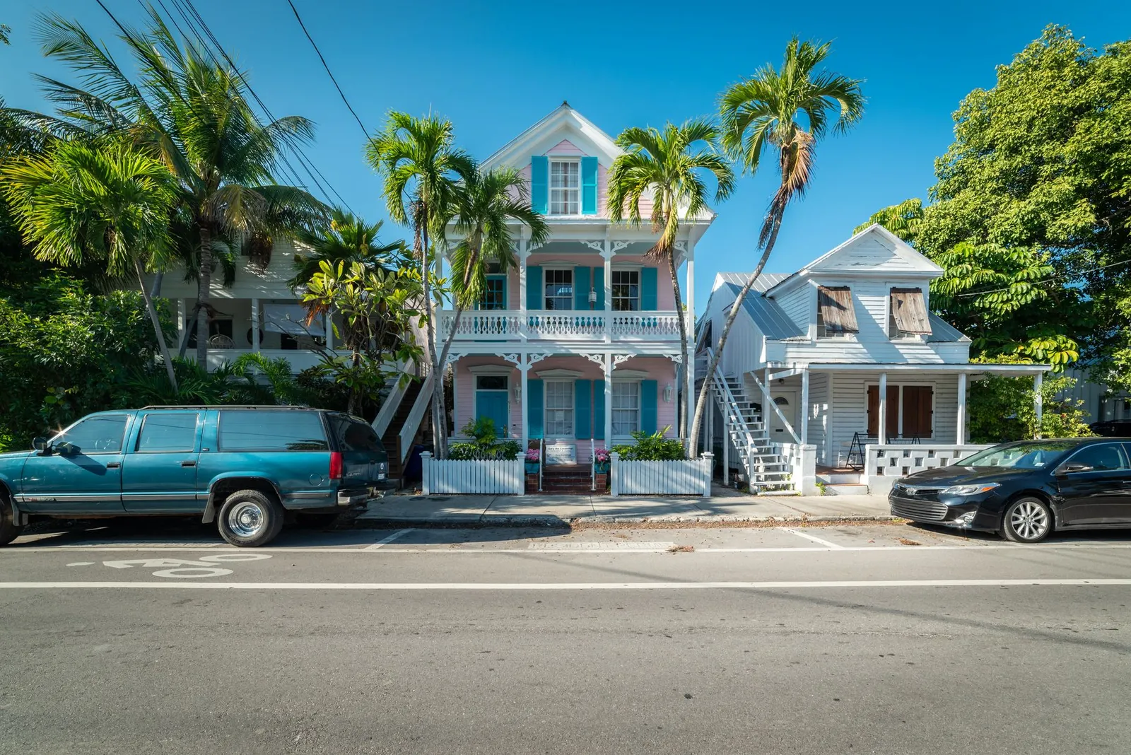 Key West: Colorful historic houses with palm trees along a sunny street in Key West, Florida.