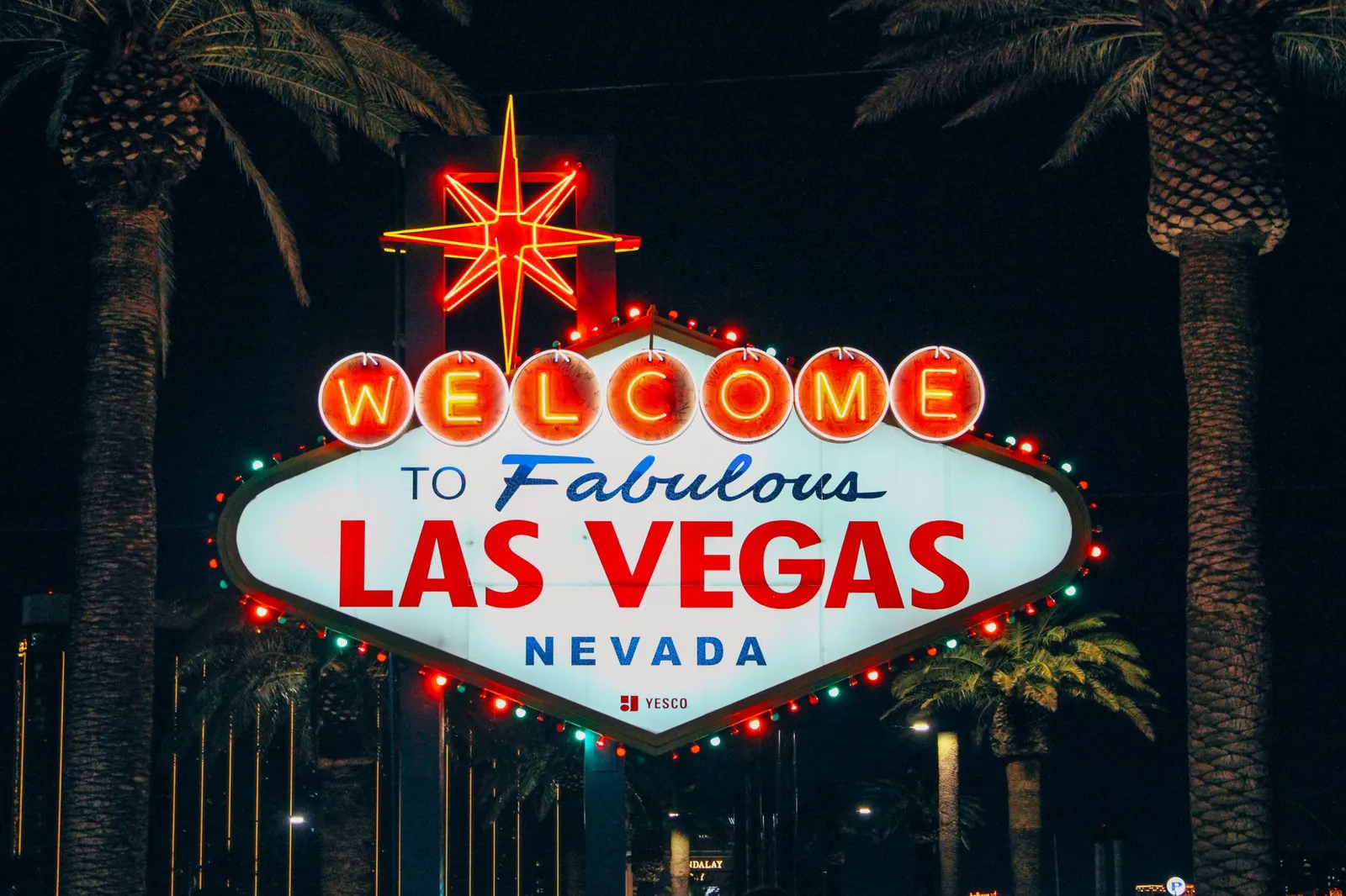 Las Vegas: The iconic Welcome to Fabulous Las Vegas sign illuminated at night with palm trees in the background.