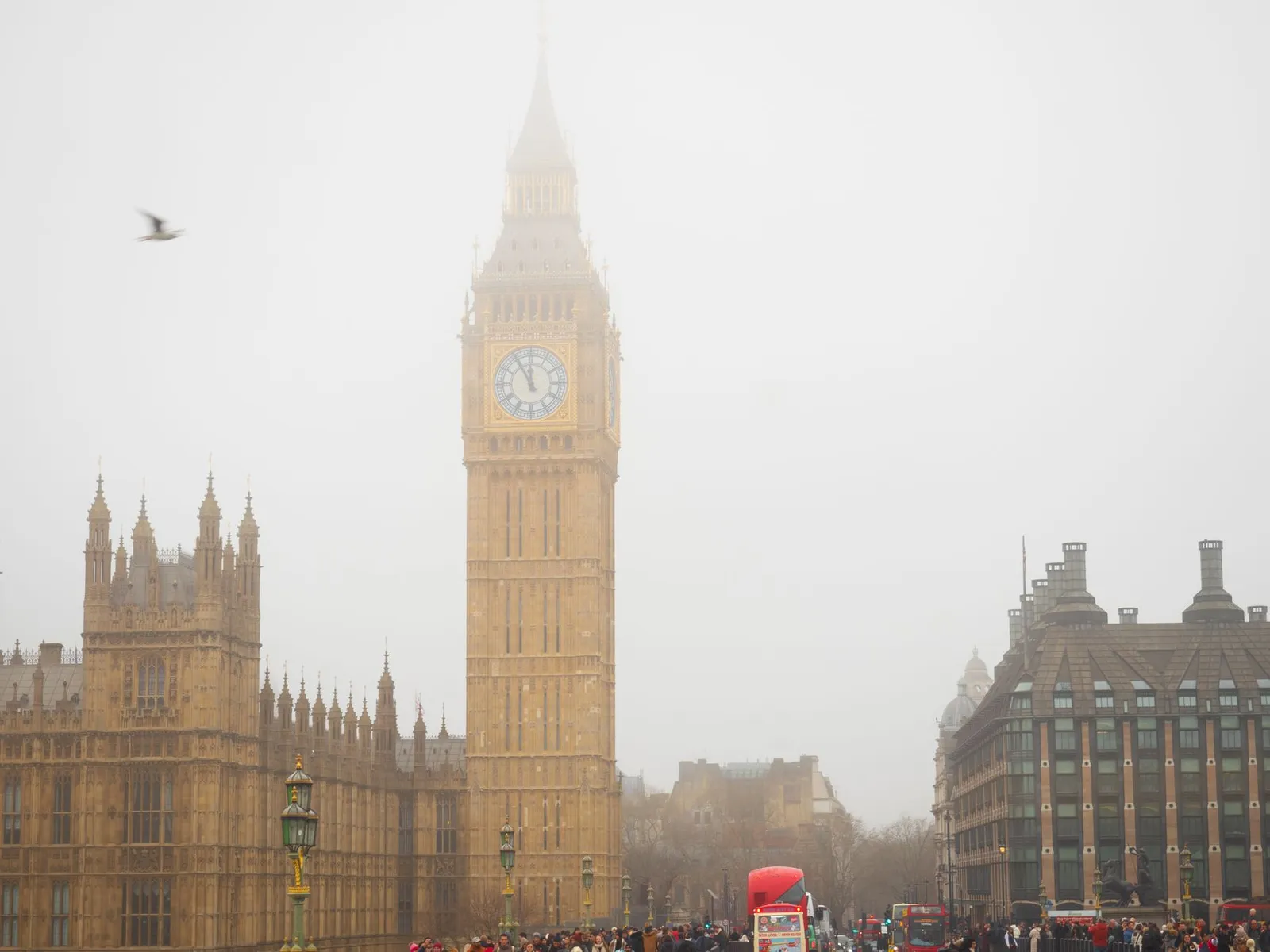 London: Iconic Big Ben tower enveloped in fog with bustling London street scene.