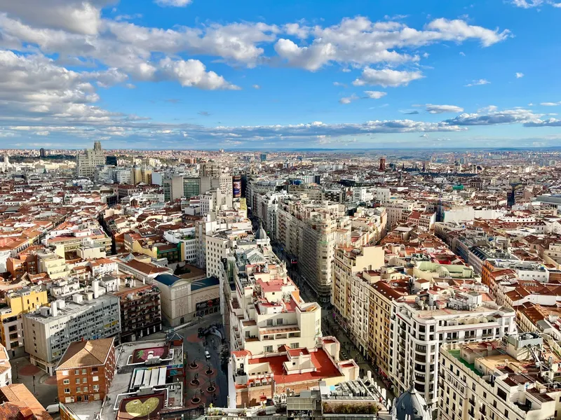 Madrid: Stunning aerial view of Madrid's skyline with vibrant cityscape under a blue sky.