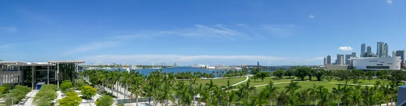 Miami: Discover the vibrant Miami skyline overlooking lush green parks and clear blue skies.