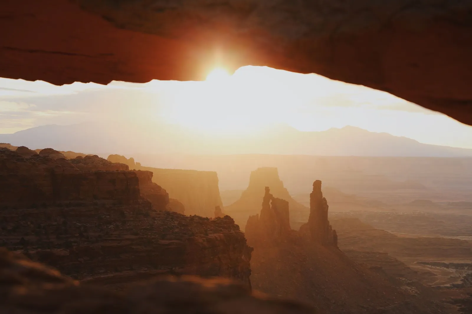 Moab (Arches & Canyonlands): Stunning sunset view through Mesa Arch in Canyonlands National Park, Utah.