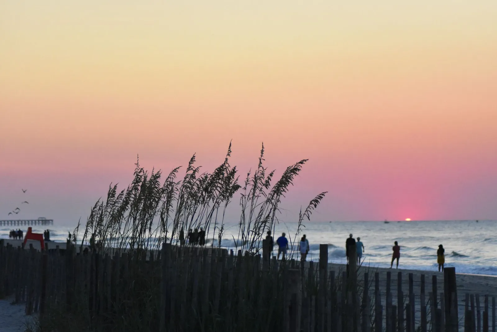 Myrtle Beach: Beautiful sunset view at Myrtle Beach with silhouettes and vibrant sky colors.