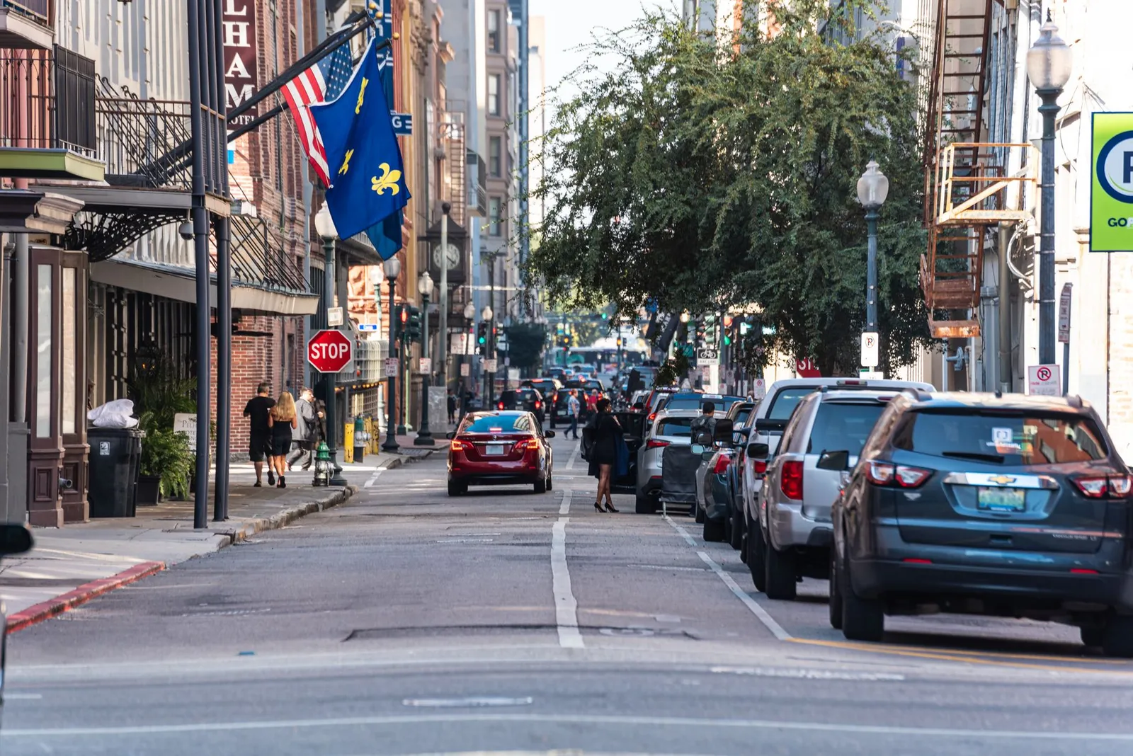 New Orleans: Bustling street in New Orleans with cars, pedestrians, and vibrant architecture.