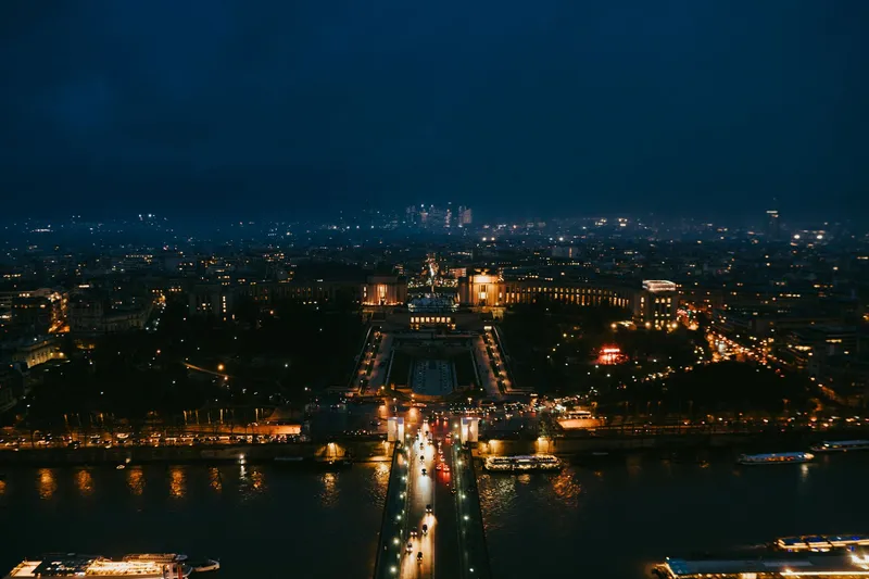 Paris: Stunning nighttime aerial cityscape of Paris highlighting iconic landmarks.