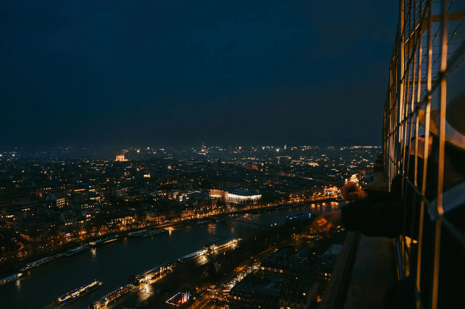 Paris: Breathtaking cityscape of Paris at night from the Eiffel Tower's perspective.