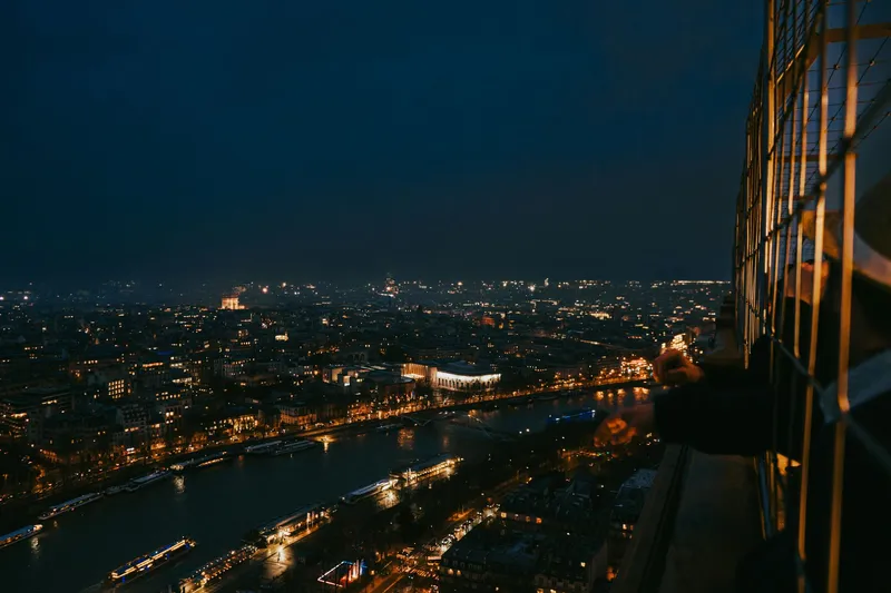 Paris: Breathtaking cityscape of Paris at night from the Eiffel Tower's perspective.