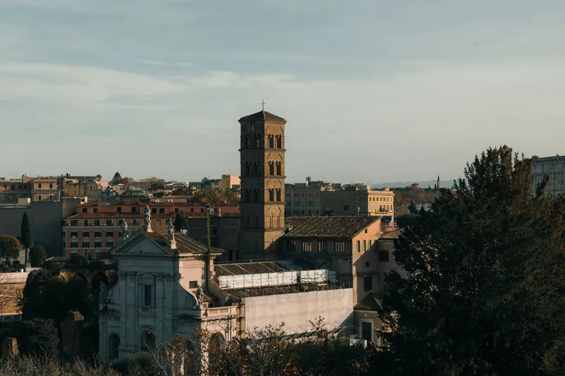 Rome: A stunning view of historic Roman architecture bathed in warm sunset light, showcasing iconic structures in Rome, Italy.