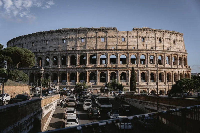 Rome: The Colosseum stands majestically amidst bustling Rome, an iconic remnant of ancient architecture.