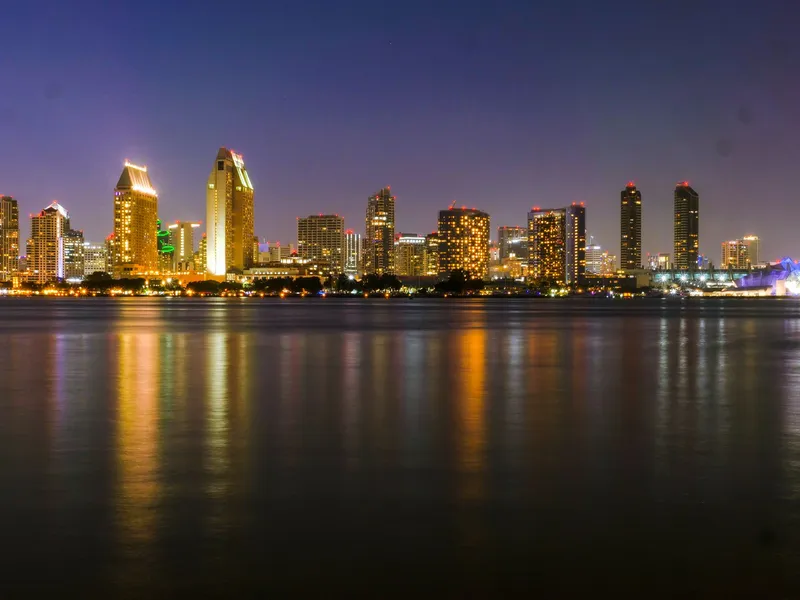 San Diego: Stunning night view of San Diego's illuminated skyline with calm waterfront reflections.