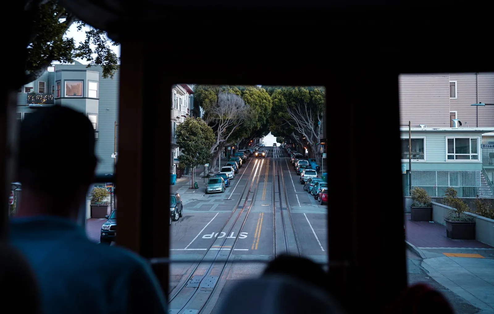 San Francisco: A scenic view of San Francisco streets from inside a moving cable car, highlighting urban transportation.