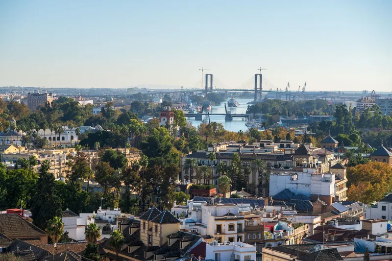 Seville: A scenic aerial view of Seville, Spain, showcasing the Isabel II Bridge and cityscape.
