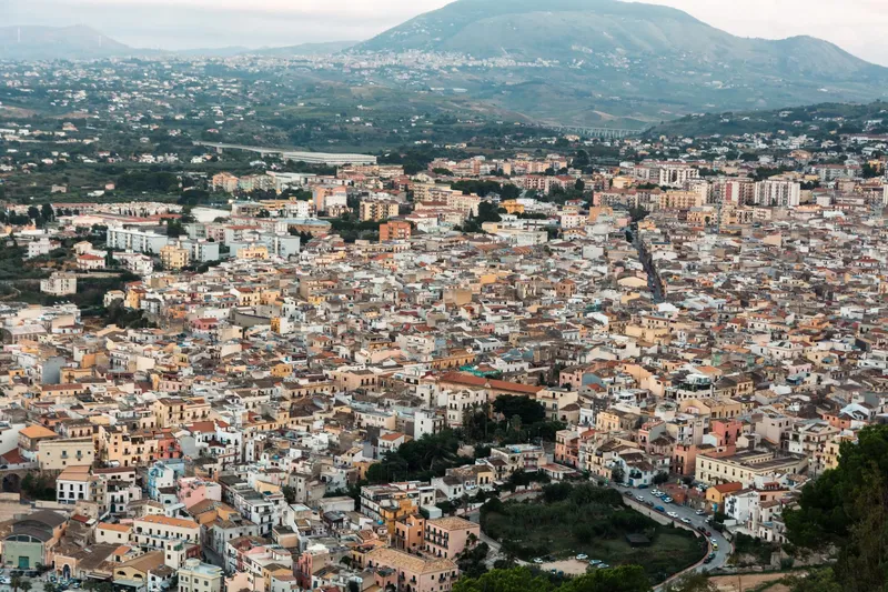 Sicily: Aerial view of Caltanissetta with dense buildings and hilly backdrop in Sicily.