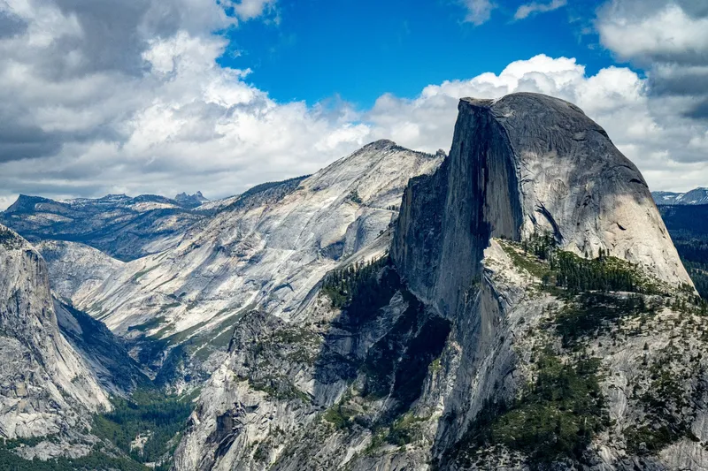 Stunning view of Half Dome in Yosemite National Park under a bright blue sky.
